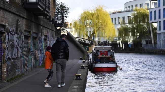 People on the empty footpath beside the Regent Canal in London. Picture: AP.