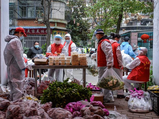 Community volunteers distributing foods ordered by residents in Wuhan, China's central Hubei province.