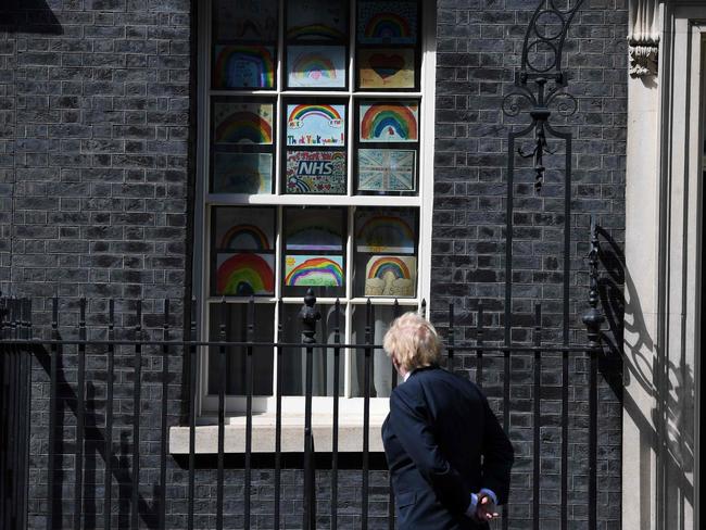 Boris Johnson stands outside 10 Downing Street to look at posters drawn by children during the COVID-19 pandemic. Picture: AFP