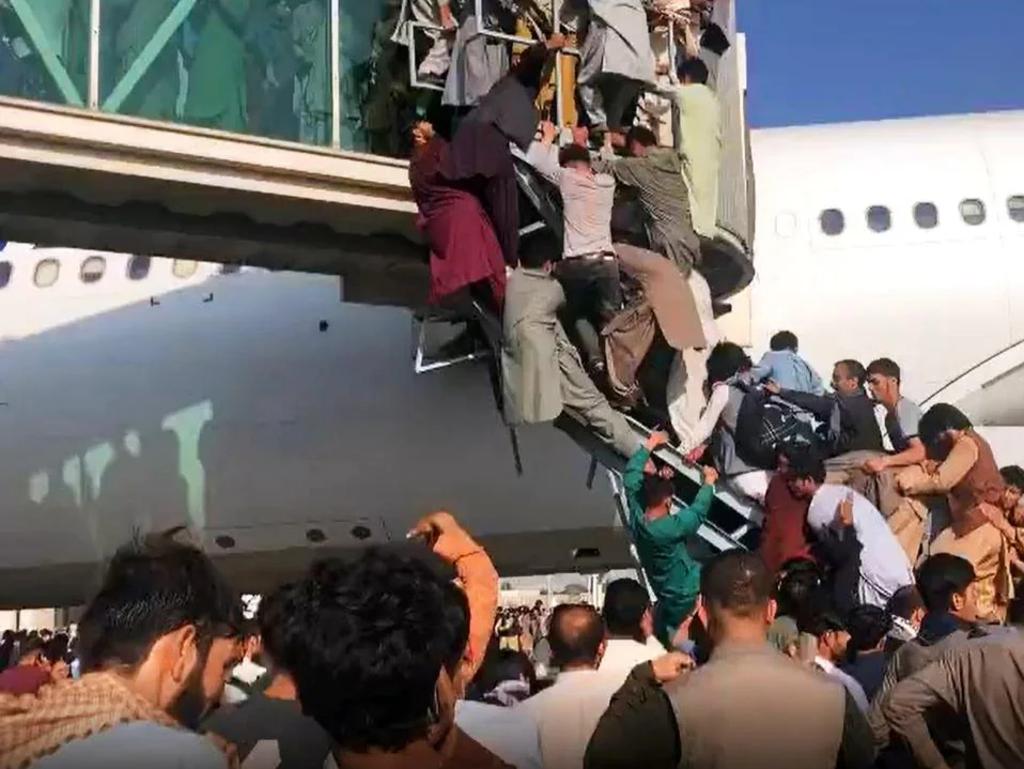 Afghans climbed onto evacuation planes as the Taliban took over, desperately trying to escape the impending violence. Picture: Twitter / @NICOLACAREEM.