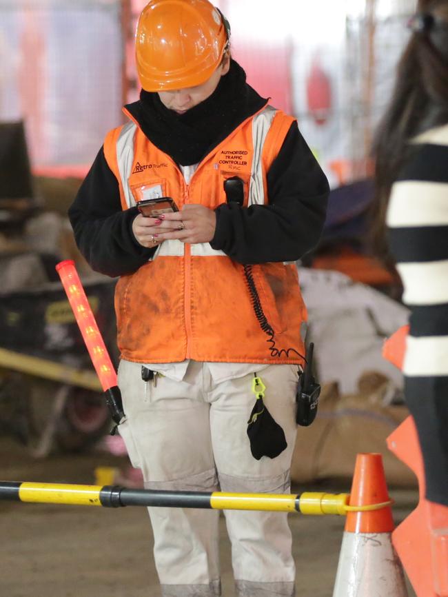 George St, city: 9.50pm. A worker on her phone. Picture: Christian Gilles