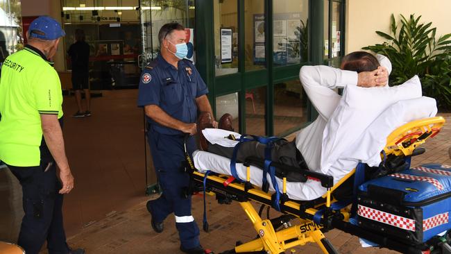 Paramedics transport Clarence Valley Council mayor Jim Simmons to a nearby ambulance.