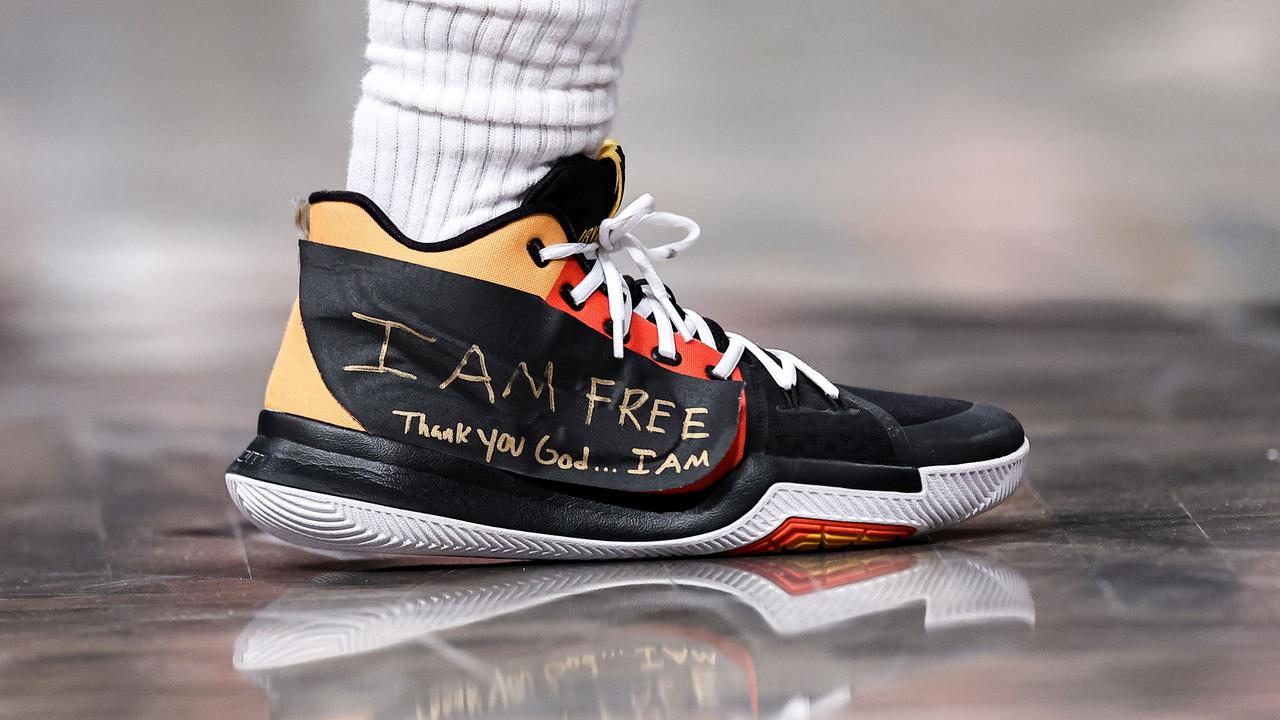 A view of the taped sneakers of Kyrie Irving. (Photo by Dustin Satloff / GETTY IMAGES NORTH AMERICA / Getty Images via AFP)