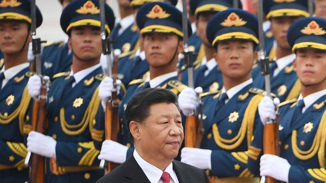 Xi Jinping walks past a military honour guard outside the Great Hall of the People in Beijing. Picture: AFP.