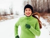 Happy young woman running in winter