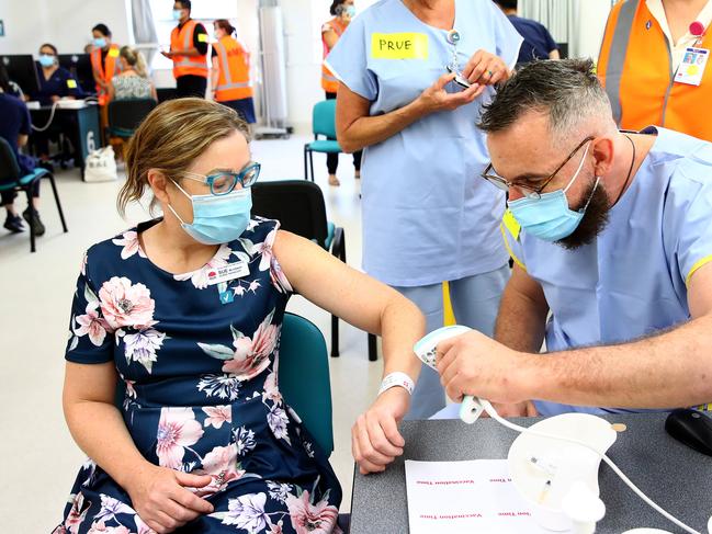 POOL PHOTOS - NSW front line health and emergency workers are amongst the first in NSW to get the Covid-19 vaccination at the Royal Prince Alfred Hospital Vaccination Hub in Camperdown. Nurse manager Sue McGrady receives the Pfizer vaccine. Picture: Toby Zerna