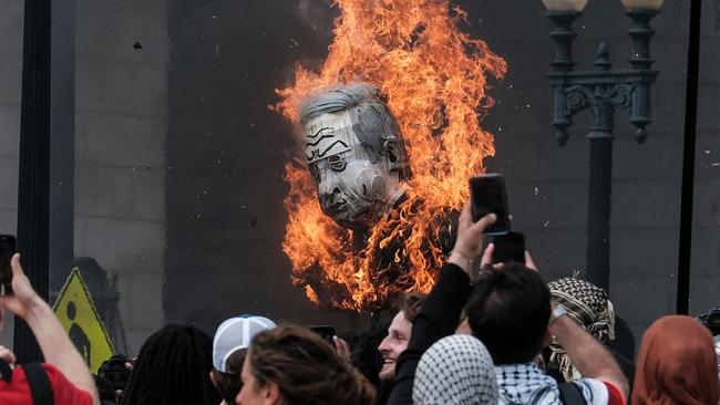 Protesters burn a photo of Mr Netanyahu. Picture: Michael A. McCoy/Getty Images via AFP