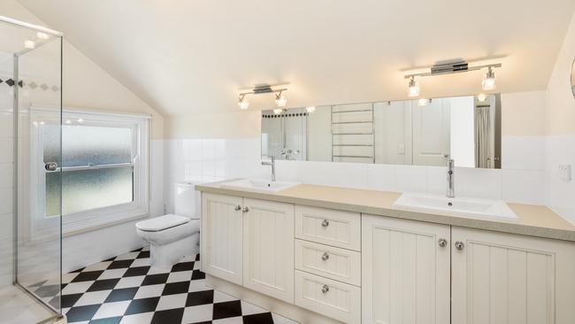 The ensuite has a stone topped vanity.