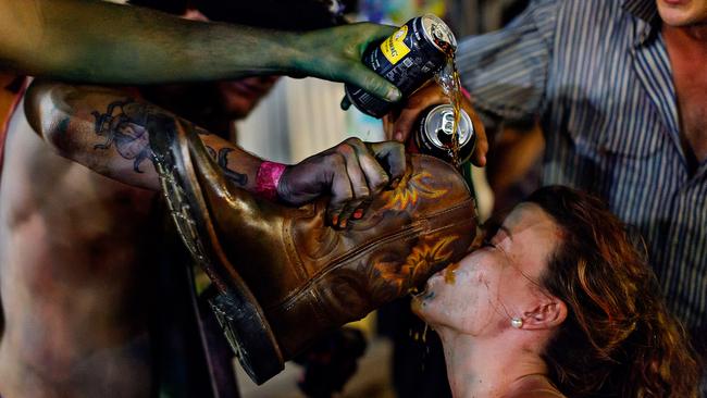 Louise Johnston does a 'shoey' and downs Bundaberg rum at the Daly Waters Easter weekend B&amp;S ball. Picture: MICHAEL FRANCHI