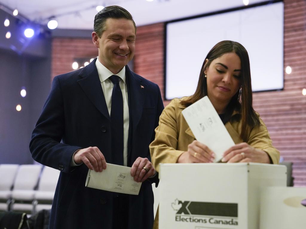 Conservative Leader Pierre Poilievre, left, looks on as his wife Anaida Poilievre casts her vote in the federal election in Ottawa, Canada. Picture: AP Photo