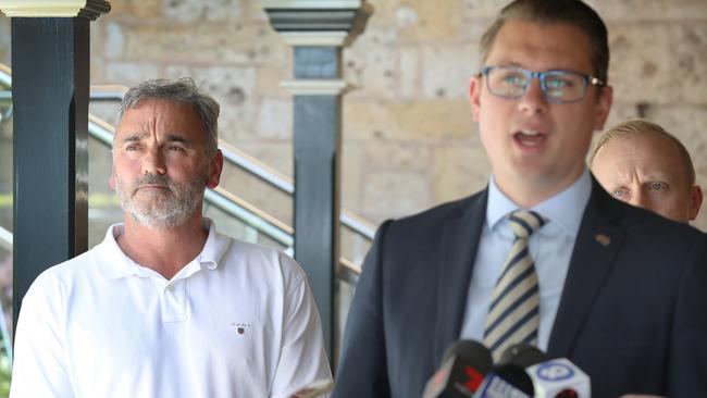 An unimpressed Keith Bradshaw of the SACA, with Transport Minister Stephan Knoll at a press conference about the train line closures. Picture: Dean Martin