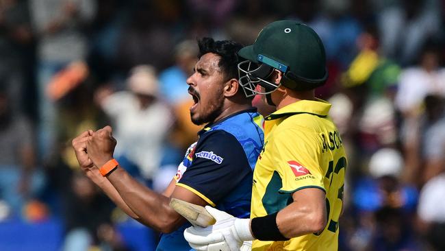 Sri Lanka's Maheesh Theekshana celebrates after taking the wicket of Australia's Marnus Labuschagne (R) during the first one-day international (ODI) cricket match between Sri Lanka and Australia at the R. Premadasa International Cricket Stadium in Colombo on February 12, 2025. (Photo by Ishara S. KODIKARA / AFP)