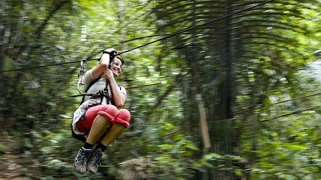 A guest at The Gibbon Experience riding part of the 52km of zip-lines in Bokeo, Laos.