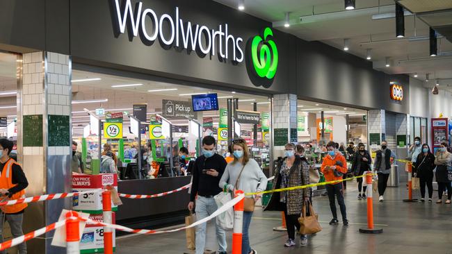 Shoppers queue to enter Woolworths in South Melbourne as Stage Four restrictions are implemented. Picture: Paul Jeffers/The Australian.