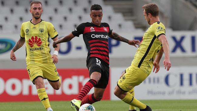 Keanu Baccus challenged by Reno Piscopo, left, and Matti Steinmann during the Wanderers game against Phoenix.