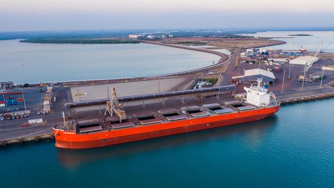 A ship laden with iron ore prepares to leave the Port of Darwin bound for China.