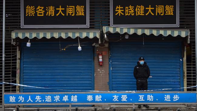 A security guard stands outside the Huanan Seafood Wholesale Market where the coronavirus was detected in Wuhan in January 24. Picture: AFP