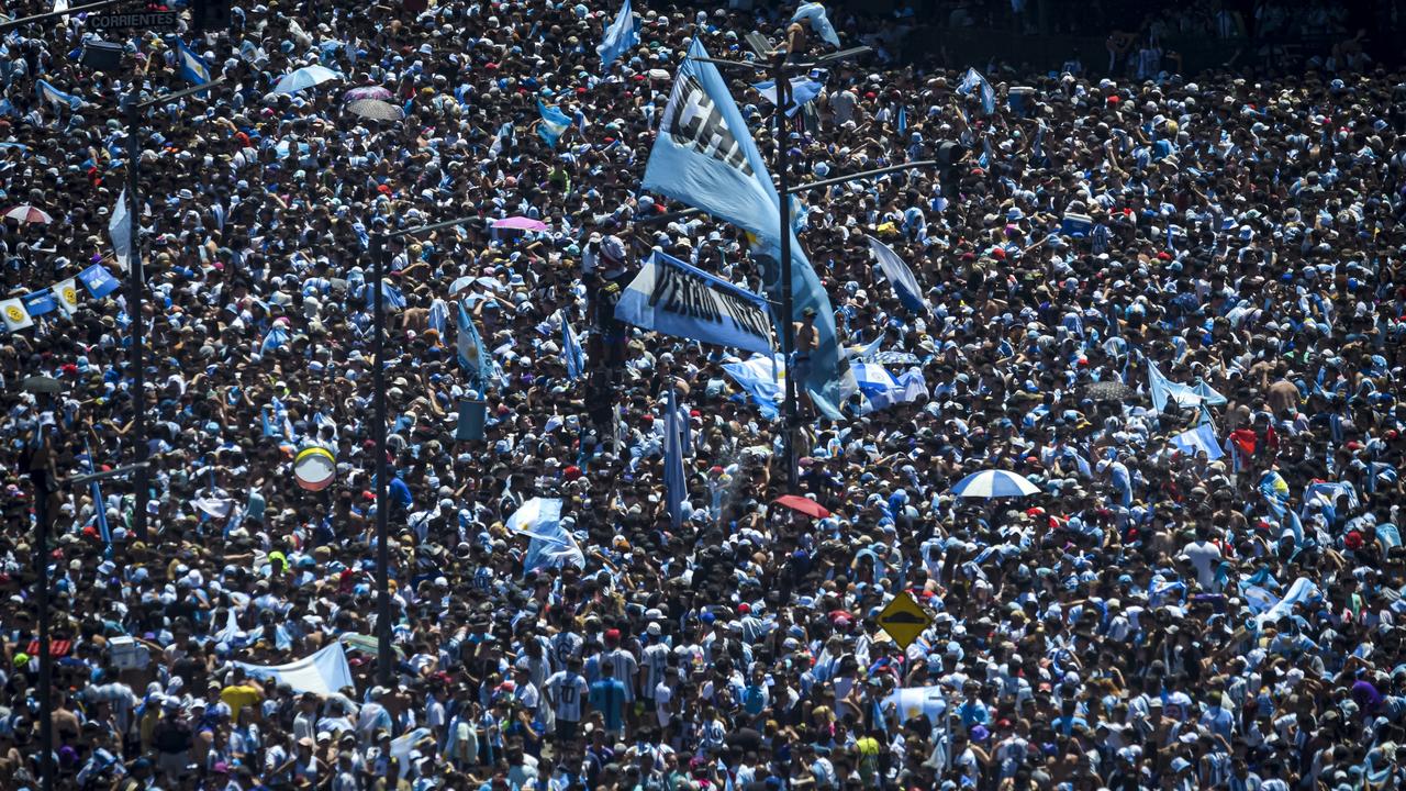 BUENOS AIRES, ARGENTINA - DECEMBER 20: A multitude of Argentine celebrate with flags and chanting as they gather for the victory parade of the Argentina men's national football team after winning the FIFA World Cup Qatar 2022 on December 20, 2022 in Buenos Aires, Argentina. (Photo by Marcelo Endelli/Getty Images)