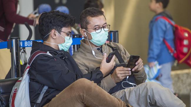 Travellers don masks at Melbourne Airport. File image: Rob Leeson.