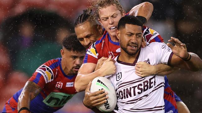 Haumole Olakau'atu is tackled by Knights players as the visitors took the spoils at McDonald Jones Stadium. Picture: Getty Images