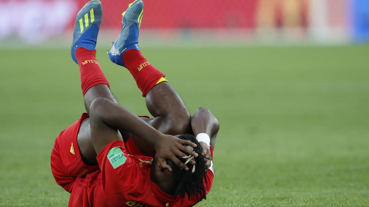 Belgium's Michy Batshuayi lies on the floor.