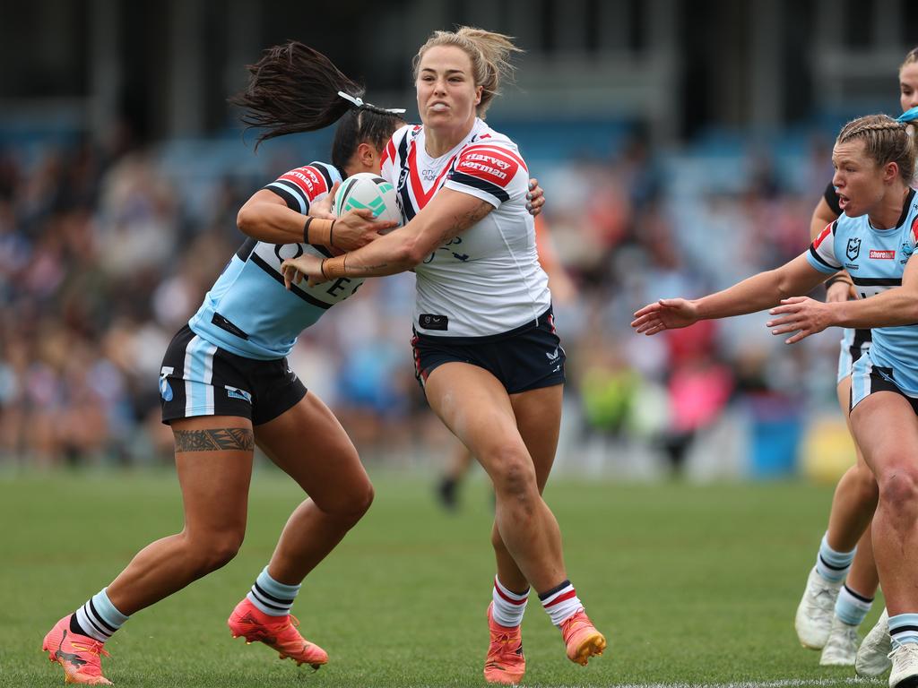 SYDNEY, AUSTRALIA - SEPTEMBER 08: Isabelle Kelly of the Roosters is tackled during the round seven NRLW match between Cronulla Sharks and Sydney Roosters at PointsBet Stadium on September 08, 2024 in Sydney, Australia. (Photo by Mark Metcalfe/Getty Images)