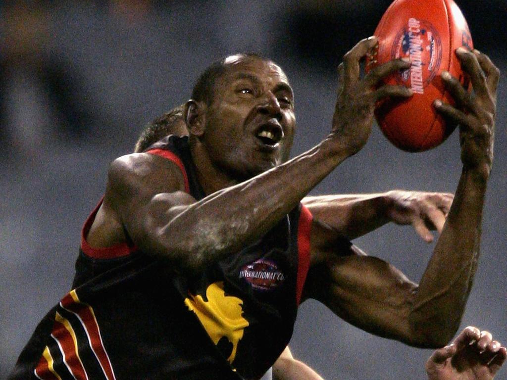 Overa Gibson takes a mark for PNG in 2005. Picture: Kristian Dowling/Getty Images