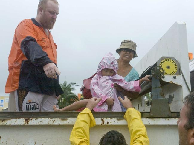 Mackay Floods: Zippora Harrison and daughter Frances, 6, after a tip truck rescue from their Valetta Gardens home during the 2008 floods.