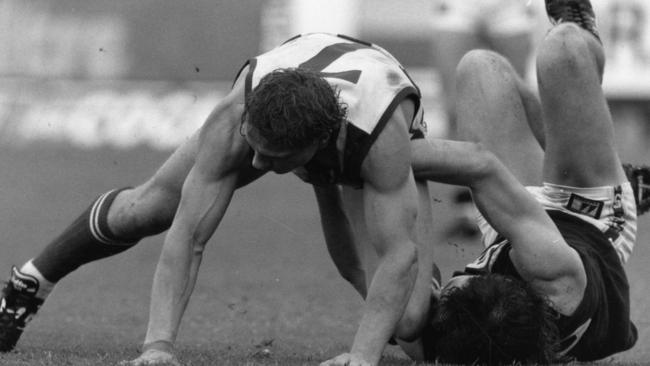 SANFL footballers Kim Klomp for North Adelaide and Mark Naley for South Adelaide (on ground) in action in 1991. Picture: File