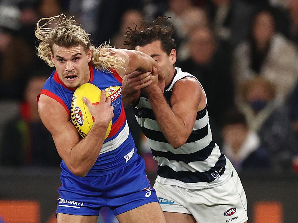 MELBOURNE. 03/06/2022.. AFL Round 12. Western Bulldogs vs Geelong at Marvel Stadium. Bulldog Bailey Smith breaks from the Luke Dahlhaus of the Cats tackle . Photo by Michael Klein