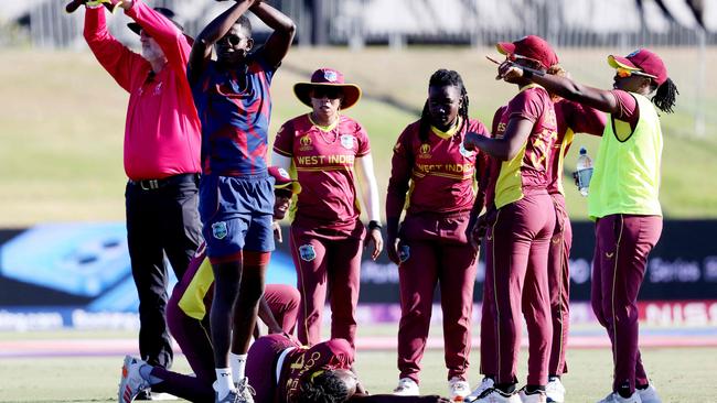 The umpire and West Indies players call for assistance after Shamilia Connell collapses. (Photo by MICHAEL BRADLEY / AFP)