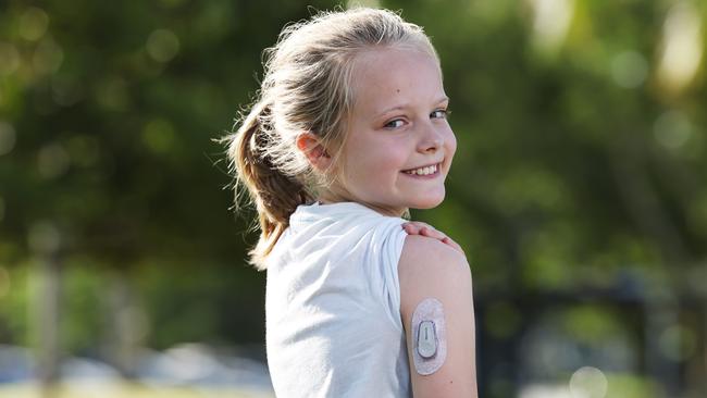 Evie proudly shows off her insulin sensor, which monitors her insulin levels. Picture: Brendan Radke