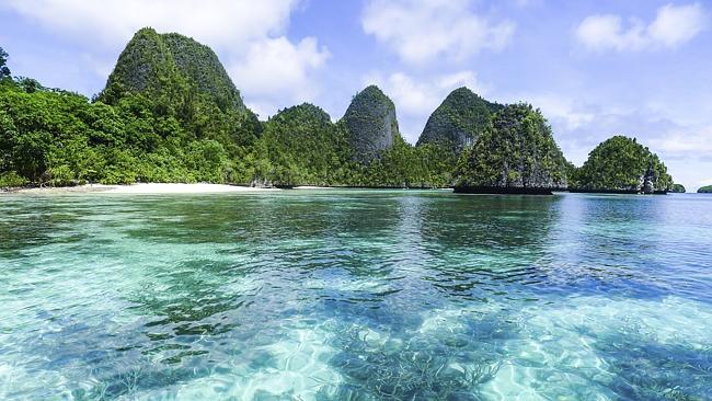 The stunning coral-coloured water and picturesque islands of Raja Ampat, Indonesia.