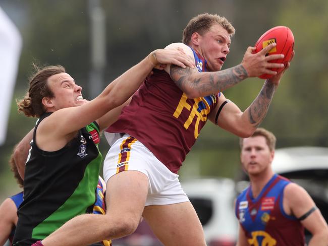 Dermott Yawney drags down a mark Pakenham. Picture: David Crosling