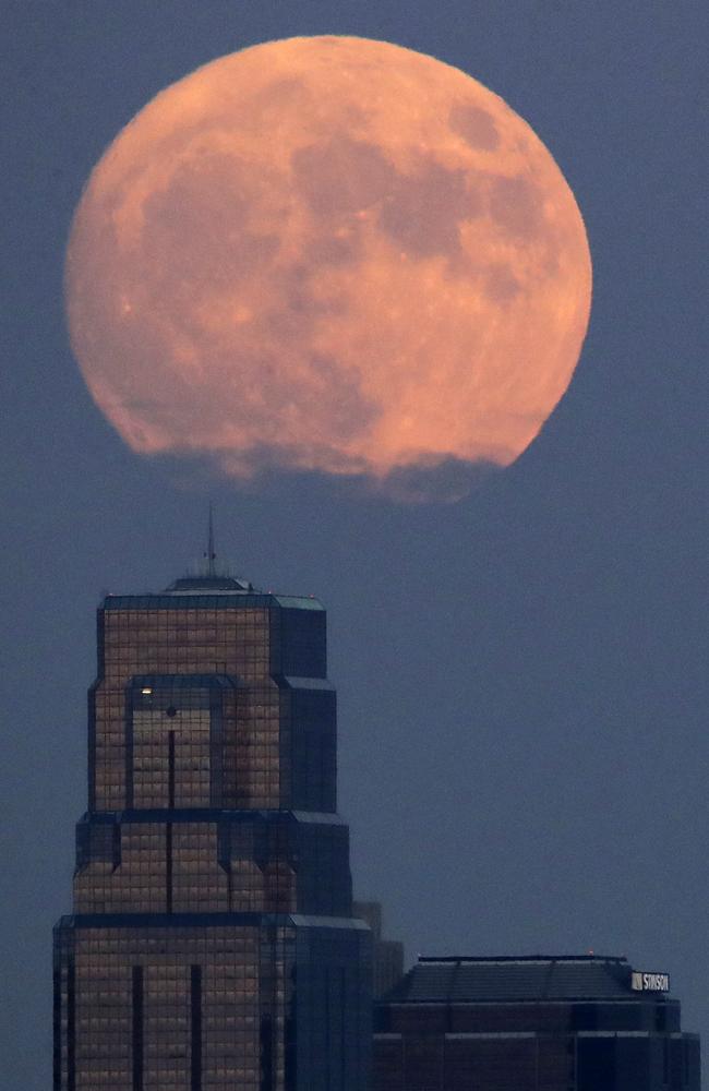 The moon rises beyond downtown buildings Sunday, Nov. 13, 2016, in Kansas City, Mo. Monday’s so-called supermoon will be extra super - it will be the closest the moon comes to us in almost 69 years. And it won’t happen again for another 18 years. Picture: AP Photo/Charlie Riedel