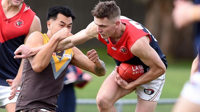 James Marchbank tries to escape Michael Tang. Picture: Steve Tanner