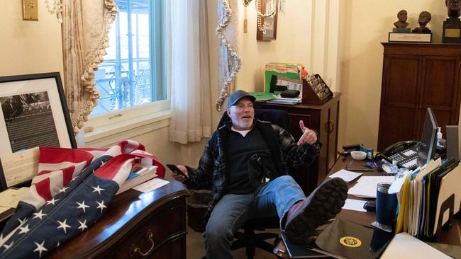 Richard Barnett makes himself comfortable at the desk of then Speaker Nancy Pelosi on January 6. Picture: AFP