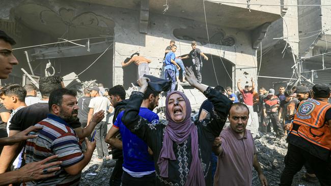 The prospect before us, therefore, is a grim one. A Palestinian woman reacts as others rush to look for victims in the rubble of a building following an Israeli strike in Khan Yunis in the southern Gaza Strip. Picture: AFP