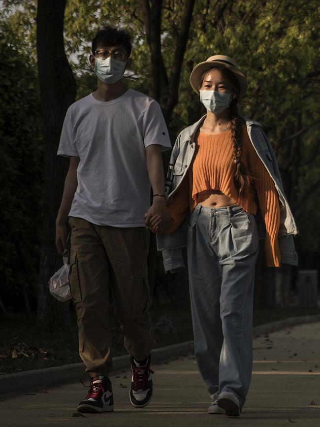 A couple walks in Jiangtan park in Wuhan. Picture: Getty Images