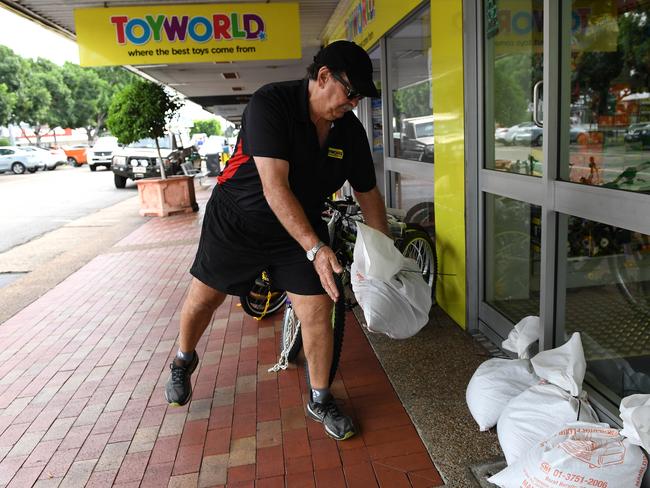 Business owner Chris Watt sandbags his Toyworld shop in Ayr yesterday ahead of Debbie’s arrival. Picture: Dan Peled/AAP