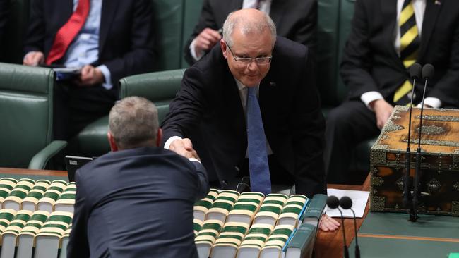 The Prime Minister and the Leader of the Opposition exchange manual pleasantries before the start of play yesterday. Picture: Kym Smith