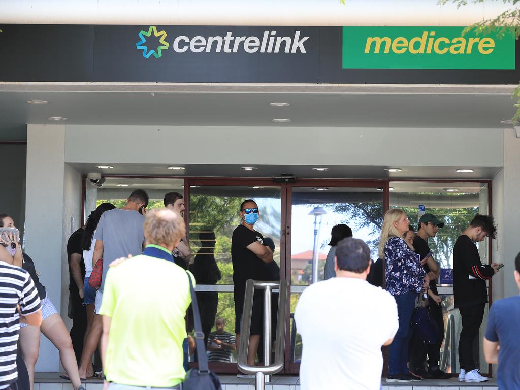 Lines of people wait at Southport Centrelink. Picture: Adam Head.