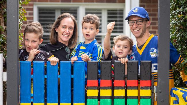 (L-R) A house divided: nine-year-old Ewan, his mum Natalie, three-year-old Joey, six-year-old Patrick and dad Dave at the family’s half and half gate. Picture: Julian Andrews