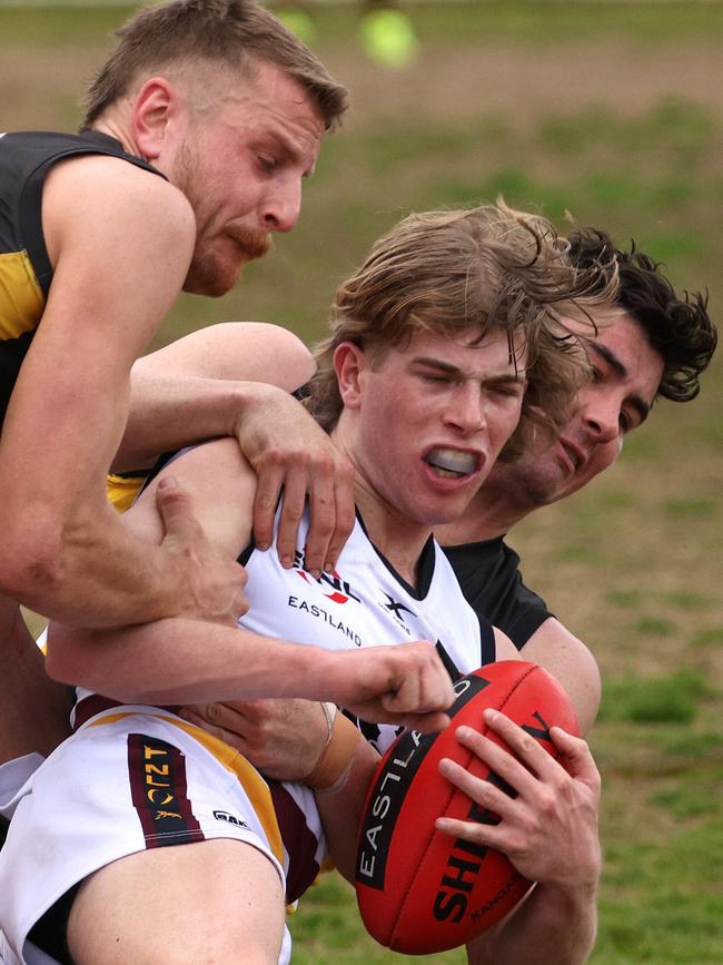 EFL: Doncaster East’s Darcy Jones-Hughes is wrapped up. Photo: Hamish Blair