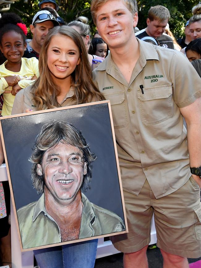 Bindi Irwin and Robert Irwin holding a portrait of their late father earlier this year. Picture: AAP