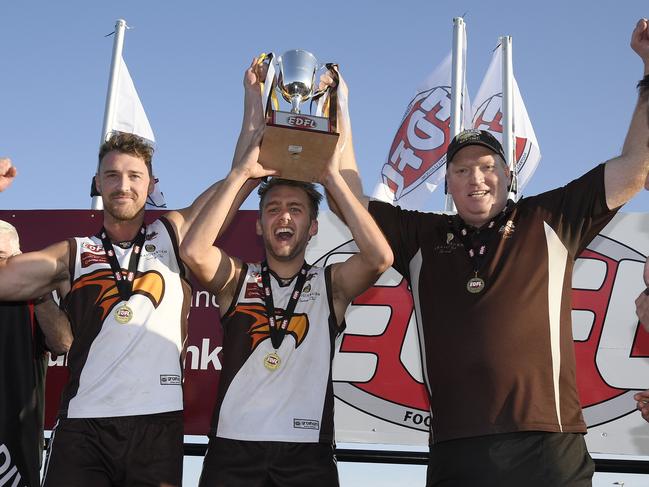 Craigieburn co-captains Christian Mcerlain and Jamie Gorgievski and coach Lance Whitnall show off the silverware. Picture: Andy Brownbill