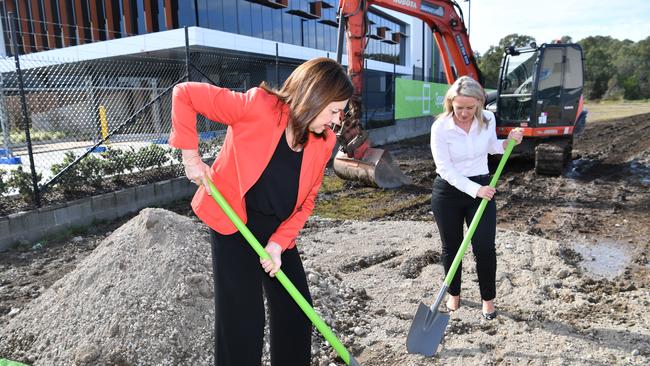 Queensland Premier Annastacia Palaszczuk and the Minister for State Development, Tourism and Innovation, Kate Jones digging at the site of the new Amazon hub. Picture: AAP Image/Darren England