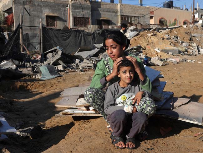 A Palestinian girl and her brother sit amid the debris of a house following an Israeli strike in Rafah in the southern Gaza Strip. Picture: AFP