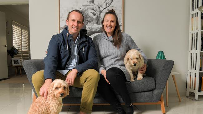 Former Aussie Diamond Susan Pettitt with her husband Brad and dogs Eric and Harvey at her Albion Park home. Picture: Simon Bullard