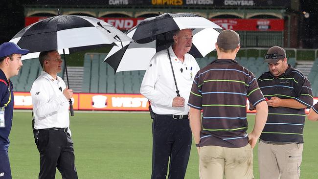 ADELAIDE, AUSTRALIA - NOVEMBER 26: Umpires Stephen Dionysius and Greg Davidson talk to Ground Staff to discuss the rain delay during the Sheffield Shield match between South Australia and Western Australia at Adelaide Oval, on November 26, 2024, in Adelaide, Australia. (Photo by Sarah Reed/Getty Images)